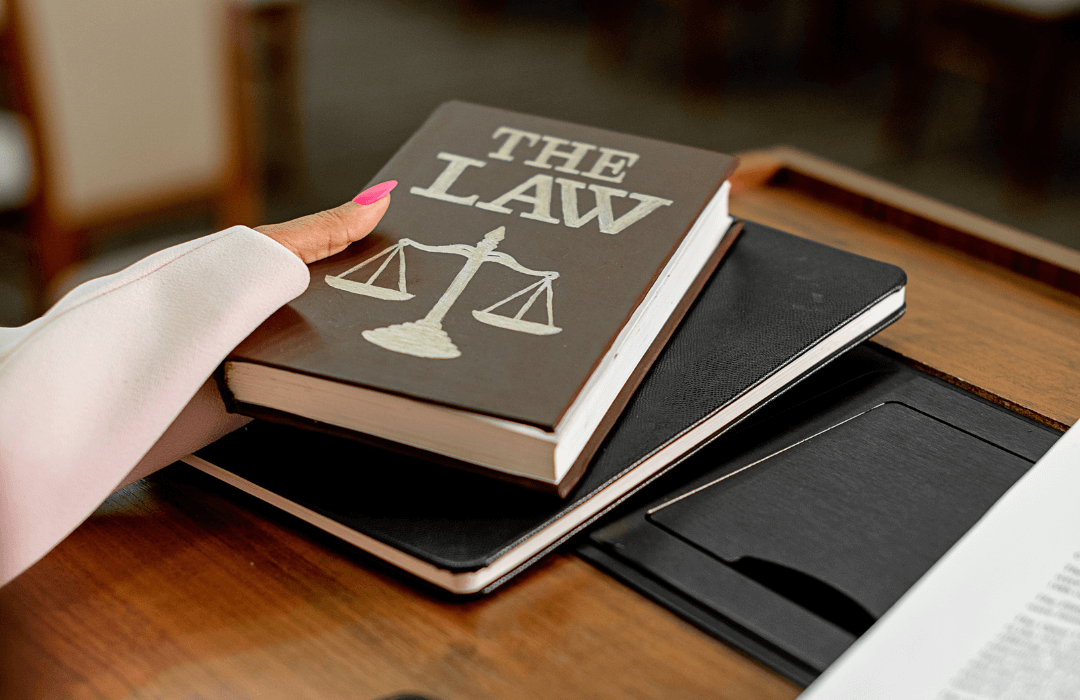 Paying for an attorney in PA - Woman with hand on law book - Stern & Cohen