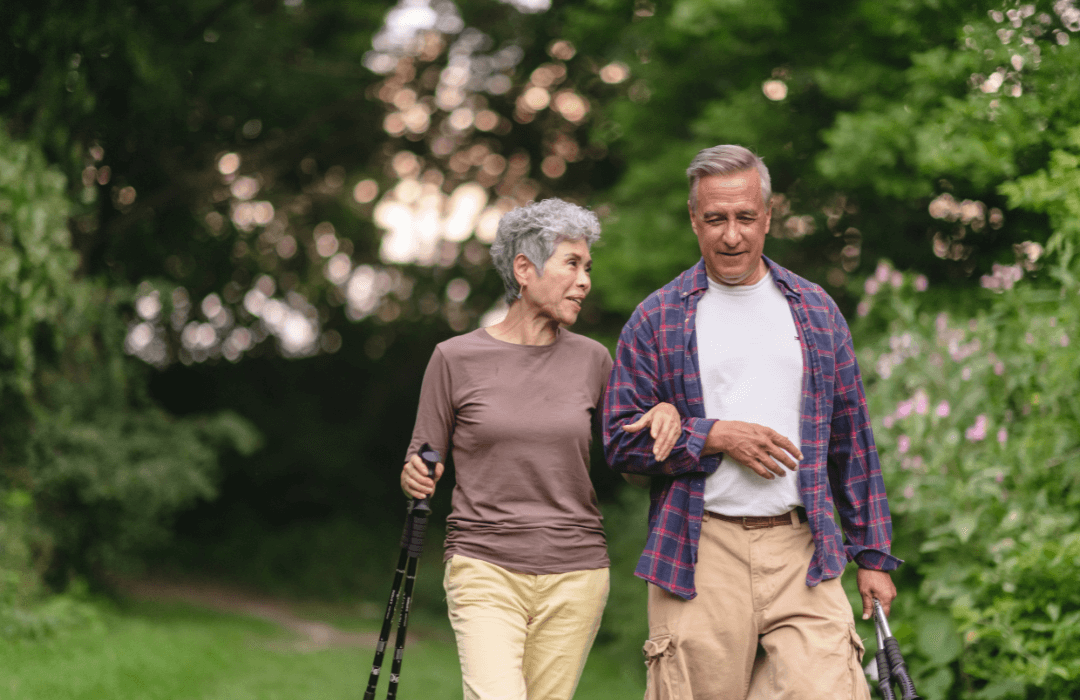 retired couple walking together in nature