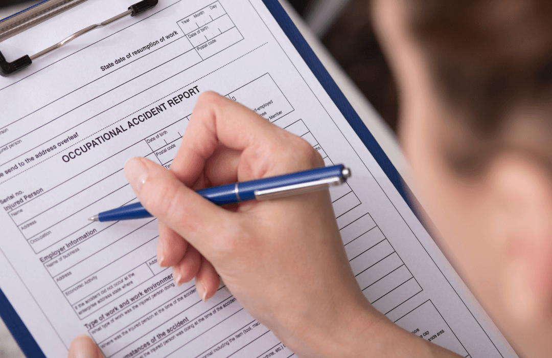 Worker filling out an occupational accident report form after a workplace injury in Pennsylvania.