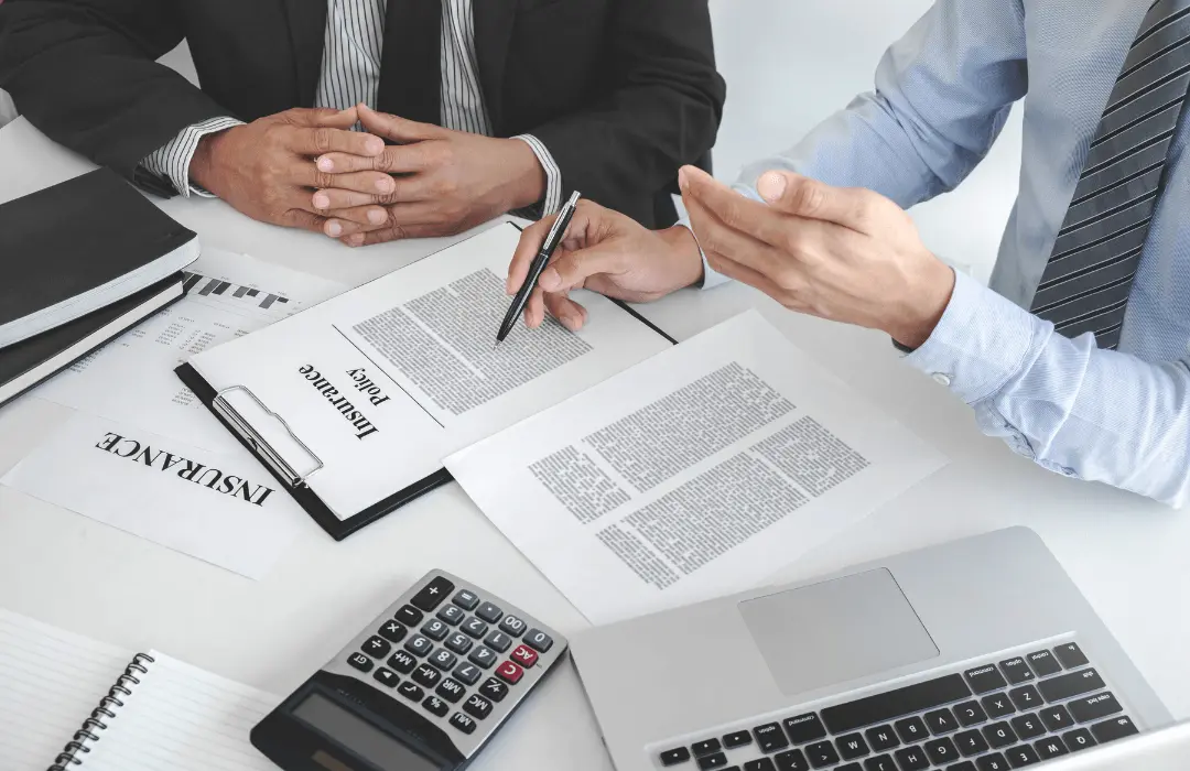 Workers’ compensation attorney reviewing a Notice of Compensation Payable (NCP) and insurance documents with an injured worker in Pennsylvania.
