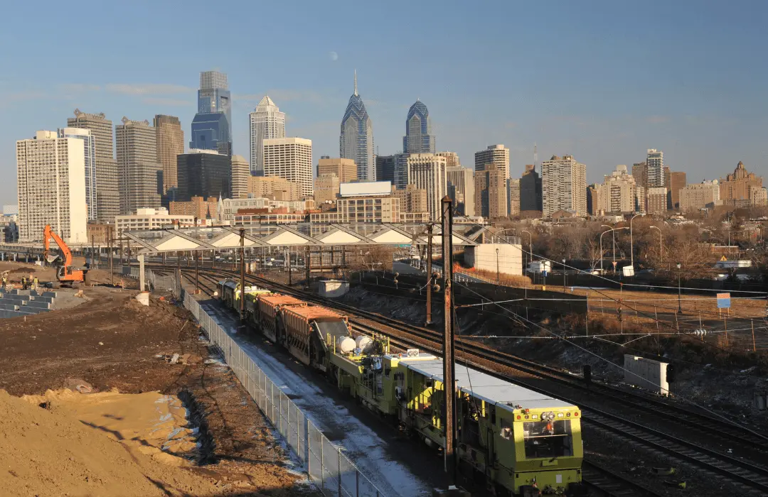 SEPTA trains and rail lines in Philadelphia with the city skyline in the background, representing workers' compensation claims for SEPTA and public transit workers in Pennsylvania.