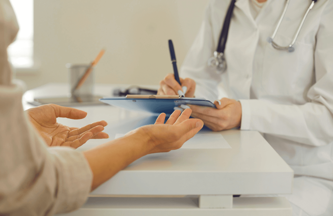 Injured worker discussing medical care with a doctor while filing a workers’ compensation insurance claim in Pennsylvania.